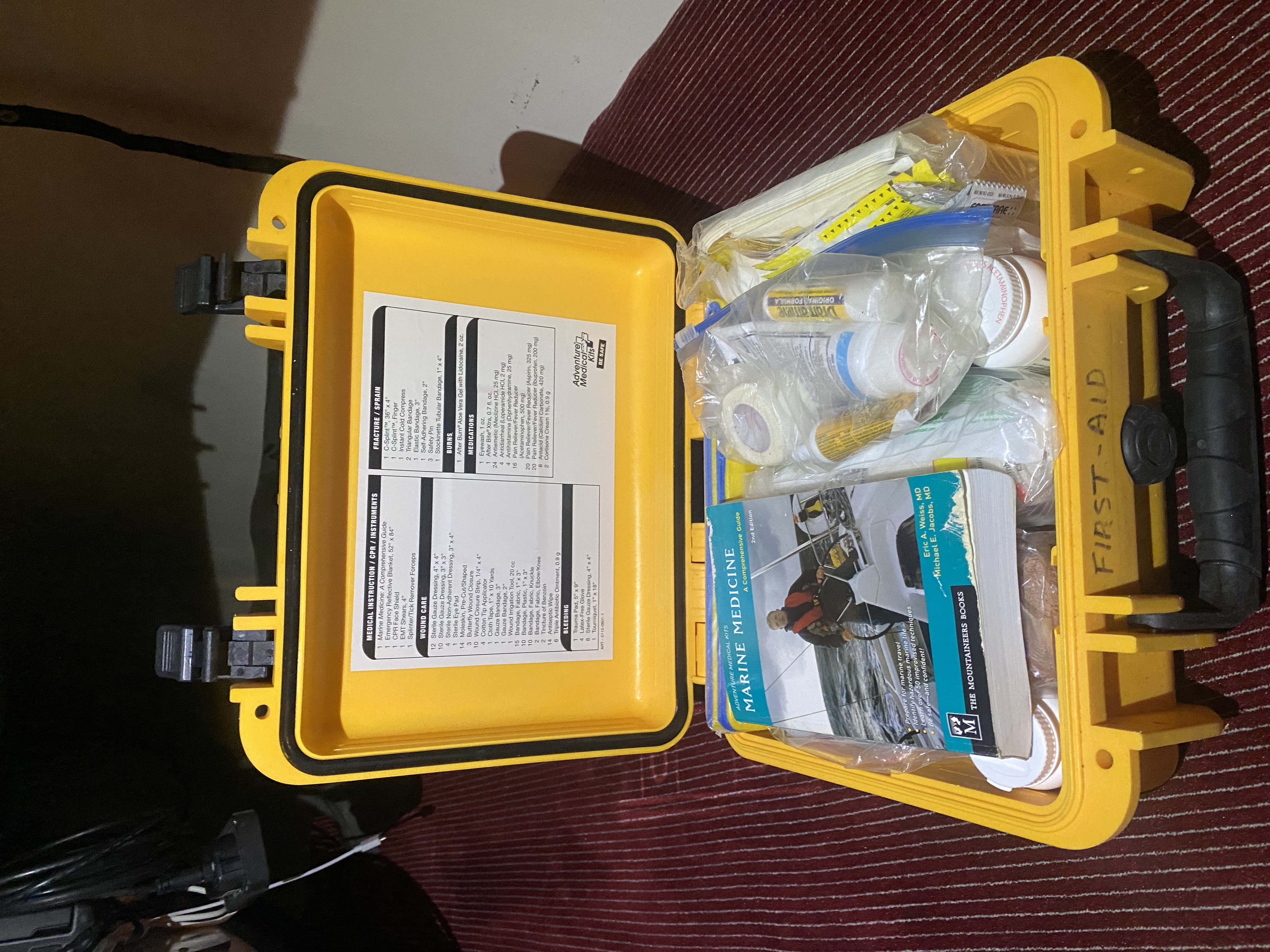 Med kit with contents on lid.